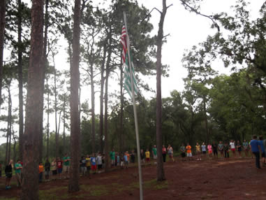 Campers outside by the flag